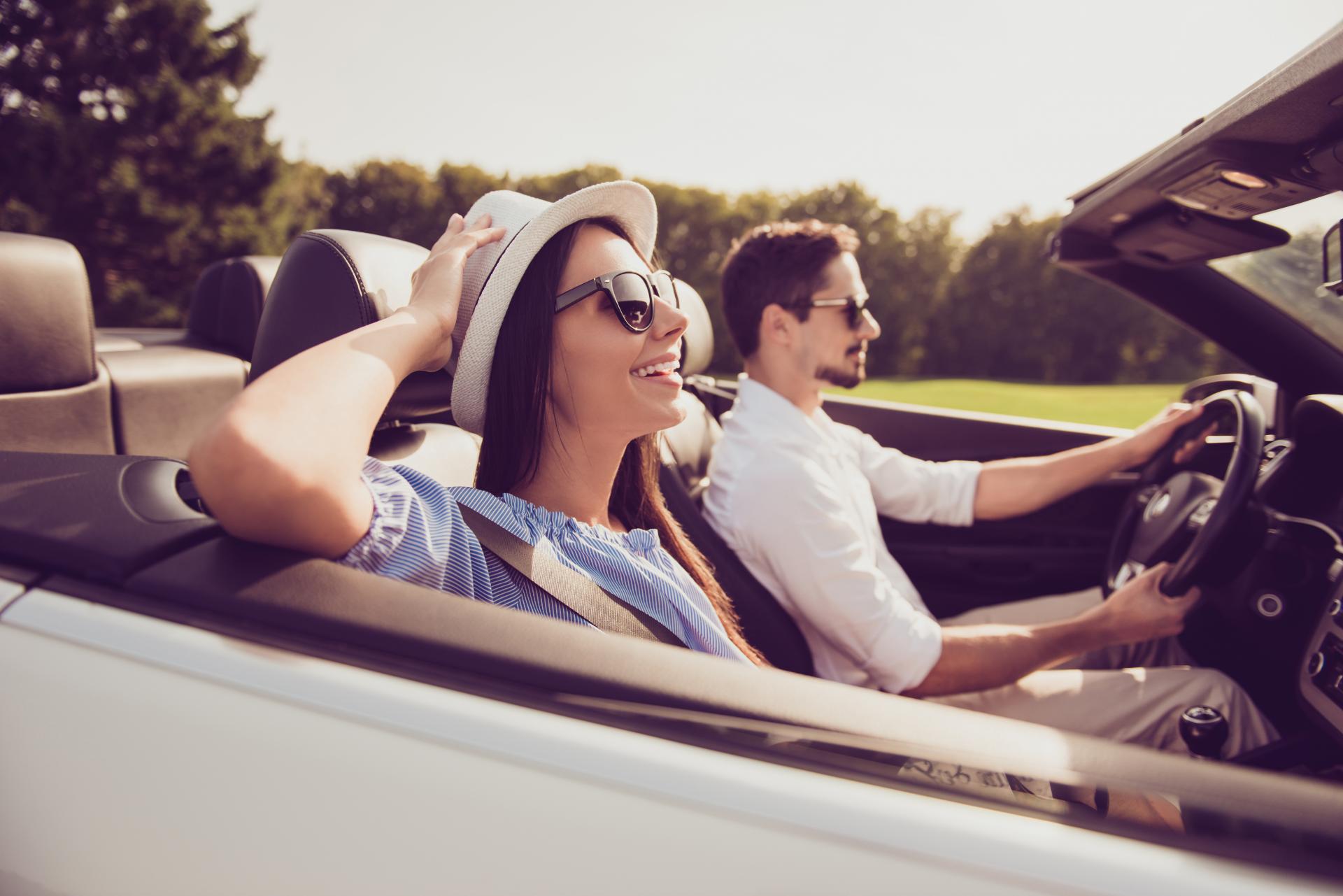 Couple driving a convertible car