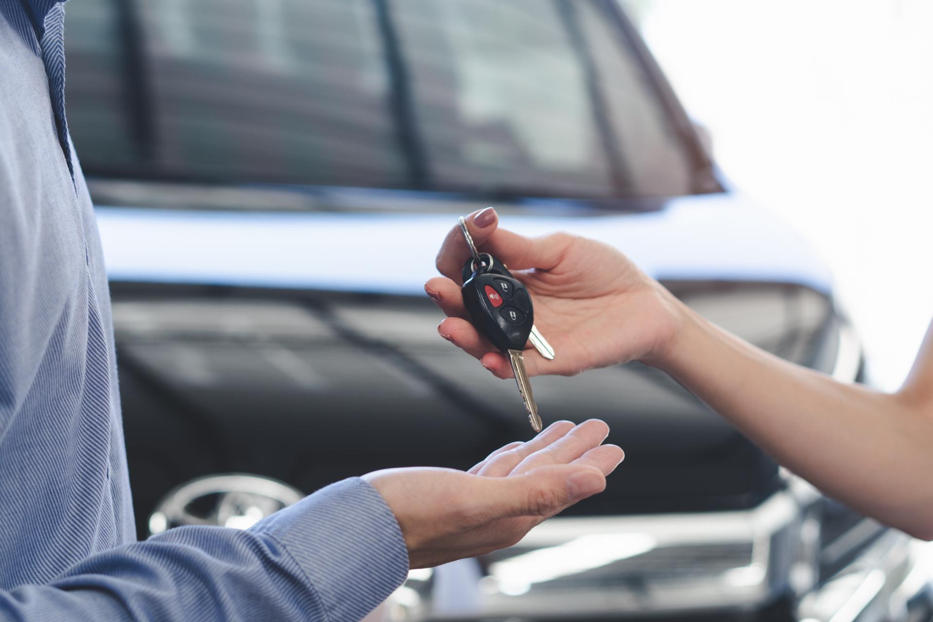 Car dealer handing keys to client